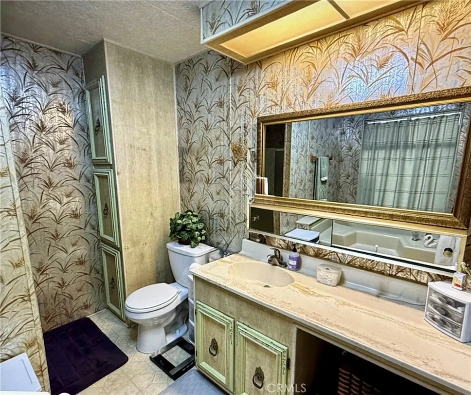 15181 Van Buren Riverside, CA 92504 - Photo 16 of 26 a bathroom with a sink a toilet and shower