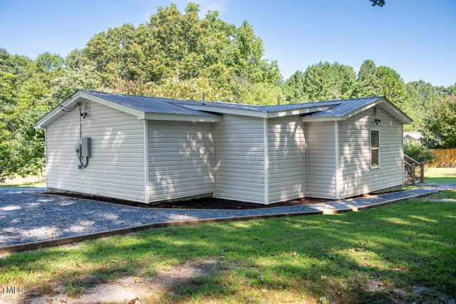 a view of a backyard with plants and a garden