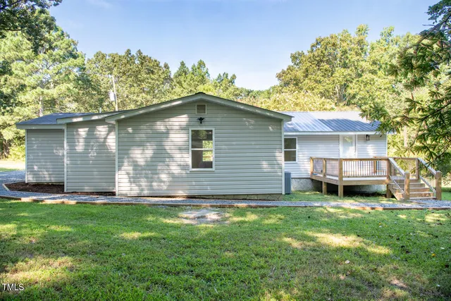 a view of a backyard with a large tree