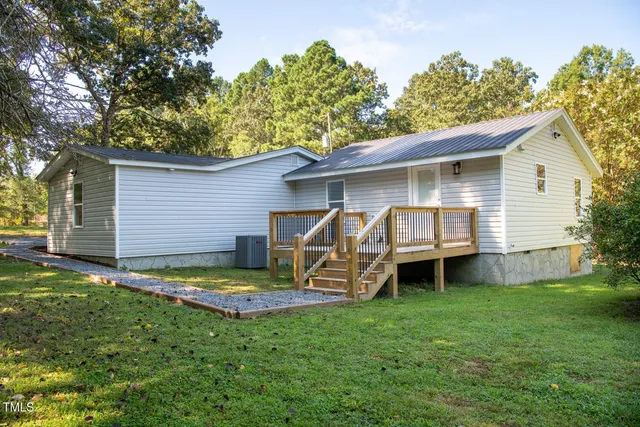 a front view of a house with a garden and yard