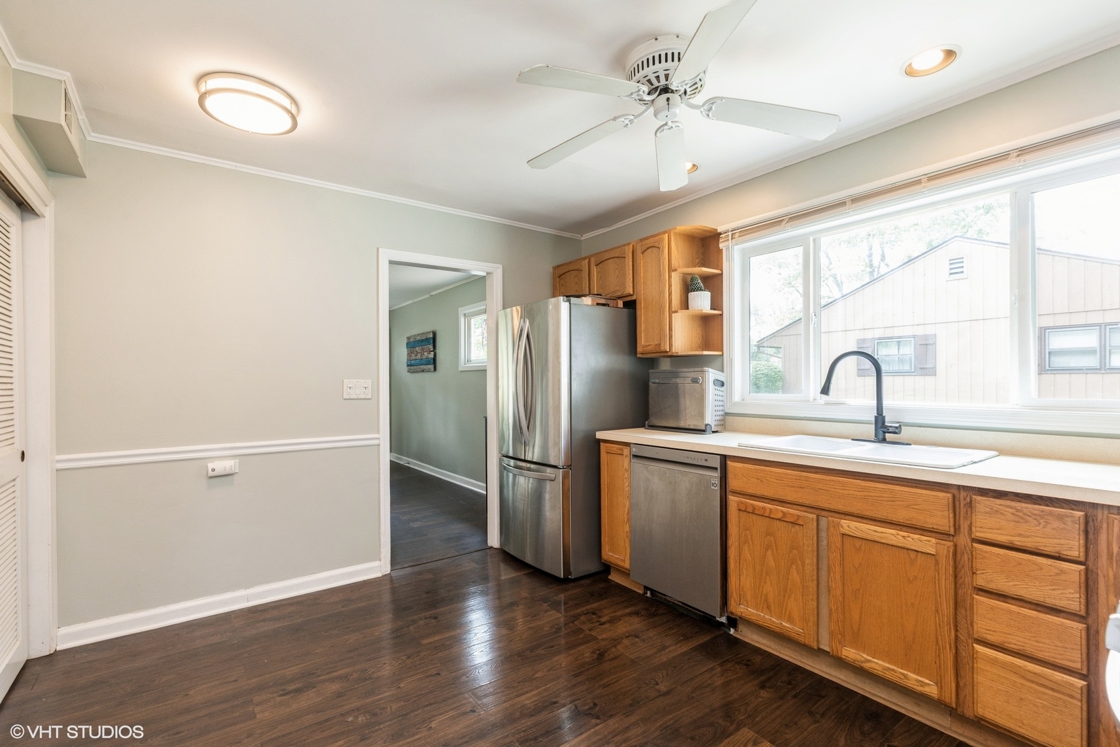 24 Johnathan Road Lake Zurich, IL 60047 - Photo 7 of 12 a kitchen with stainless steel appliances a sink cabinets and wooden floor