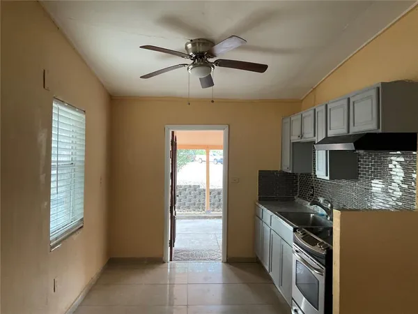 a kitchen with stainless steel appliances granite countertop a stove sink and cabinets
