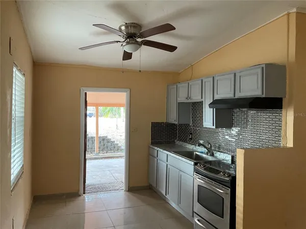 a kitchen with stainless steel appliances granite countertop a stove sink and cabinets