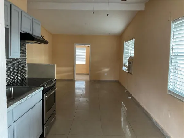 a kitchen that has a sink and a stove