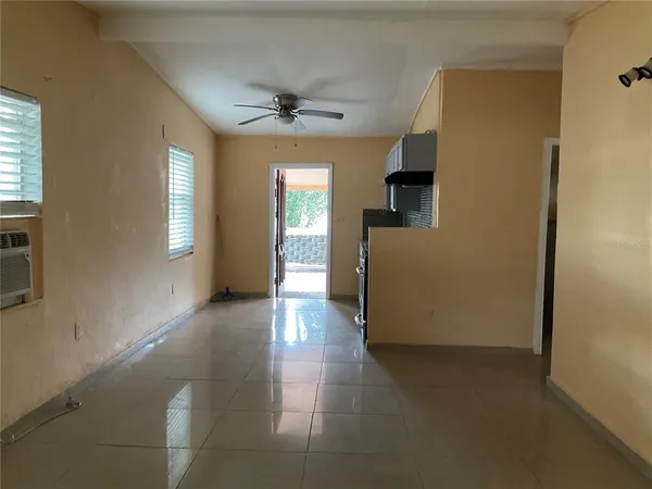 an empty room with windows and cabinet