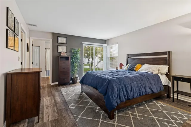 a bedroom with a bed and wooden cabinets
