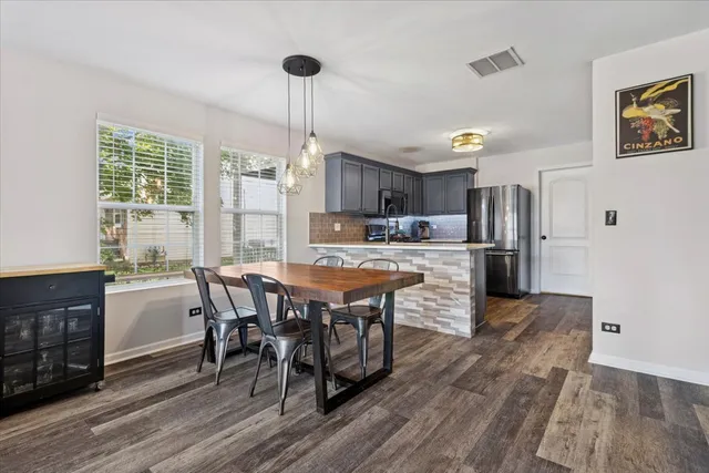 a large kitchen with a table and chairs