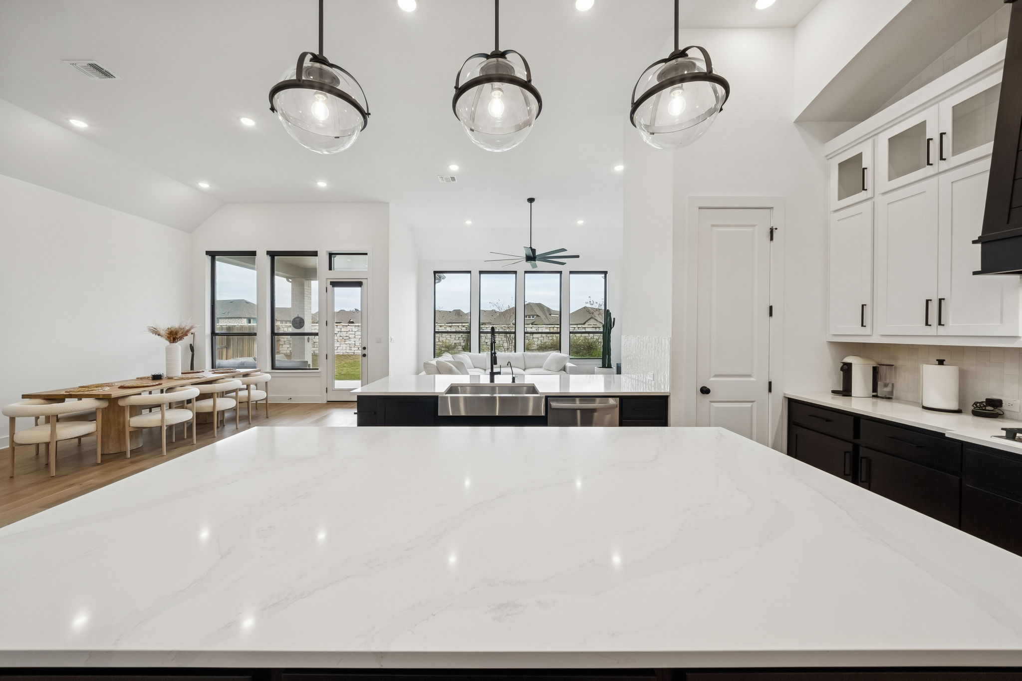 269 Iron Crk Way Kyle, TX 78640 - Photo 11 of 32 a large white kitchen with a large window and stainless steel appliances