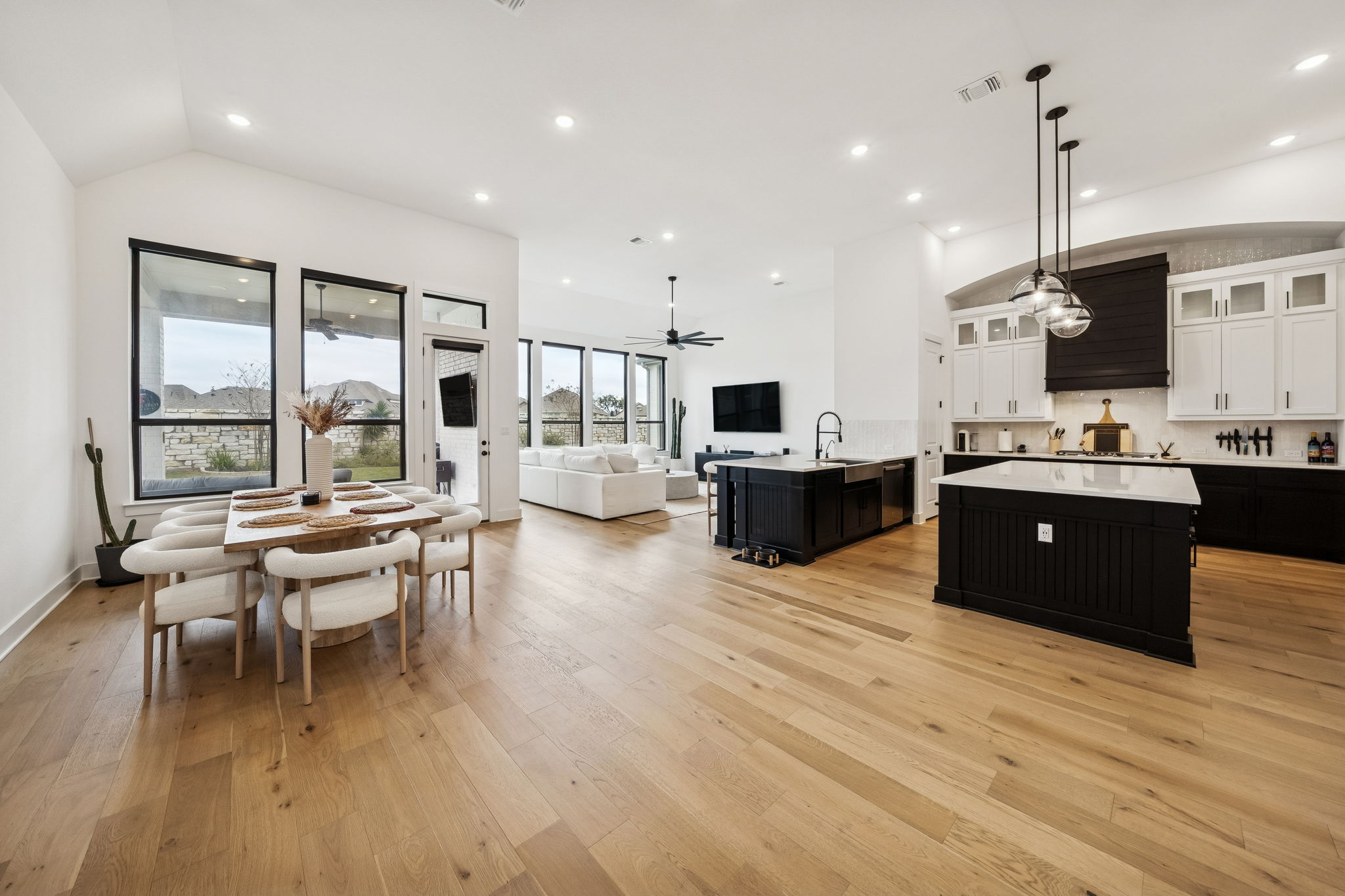 269 Iron Crk Way Kyle, TX 78640 - Photo 32 of 32 a kitchen with stainless steel appliances kitchen island granite countertop a stove top oven a sink dishwasher a dining table and chairs with wooden floor