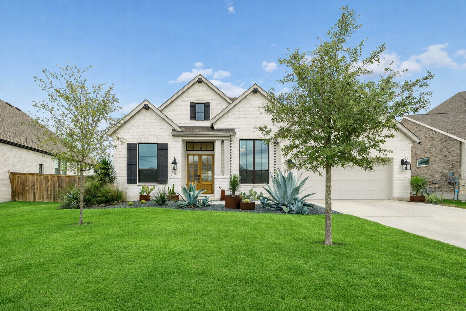 a front view of house with yard and green space