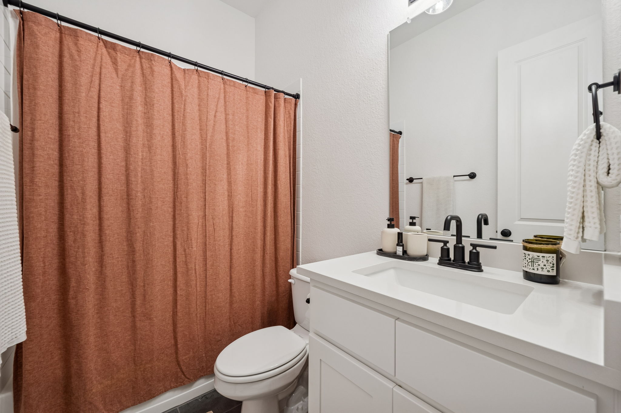 269 Iron Crk Way Kyle, TX 78640 - Photo 21 of 32 a bathroom with a sink a toilet and shower curtain