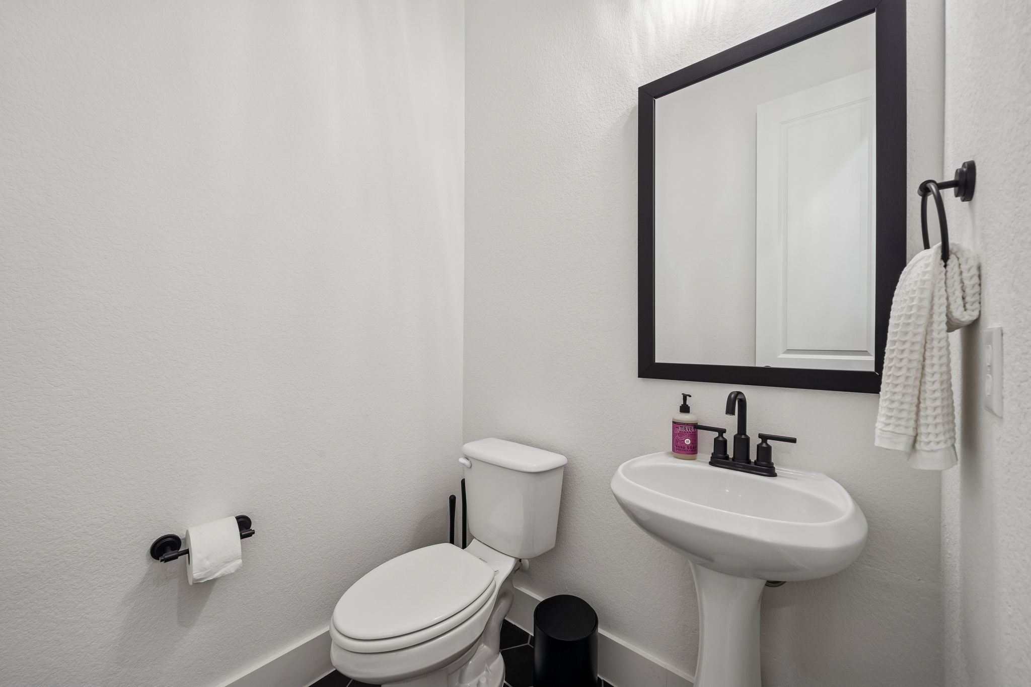 269 Iron Crk Way Kyle, TX 78640 - Photo 23 of 32 a bathroom with a sink a toilet and mirror