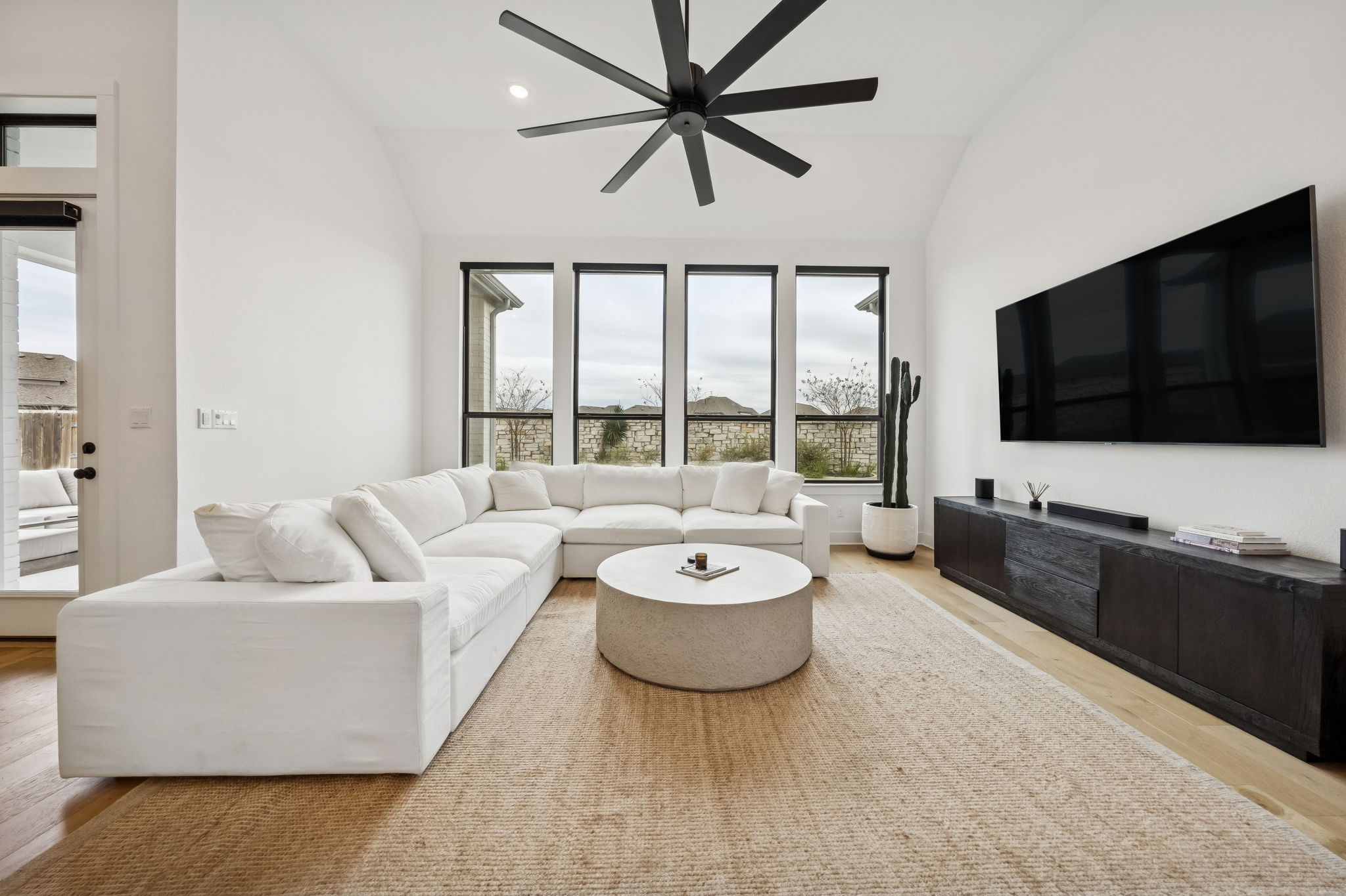 269 Iron Crk Way Kyle, TX 78640 - Photo 4 of 32 a living room with furniture and a flat screen tv