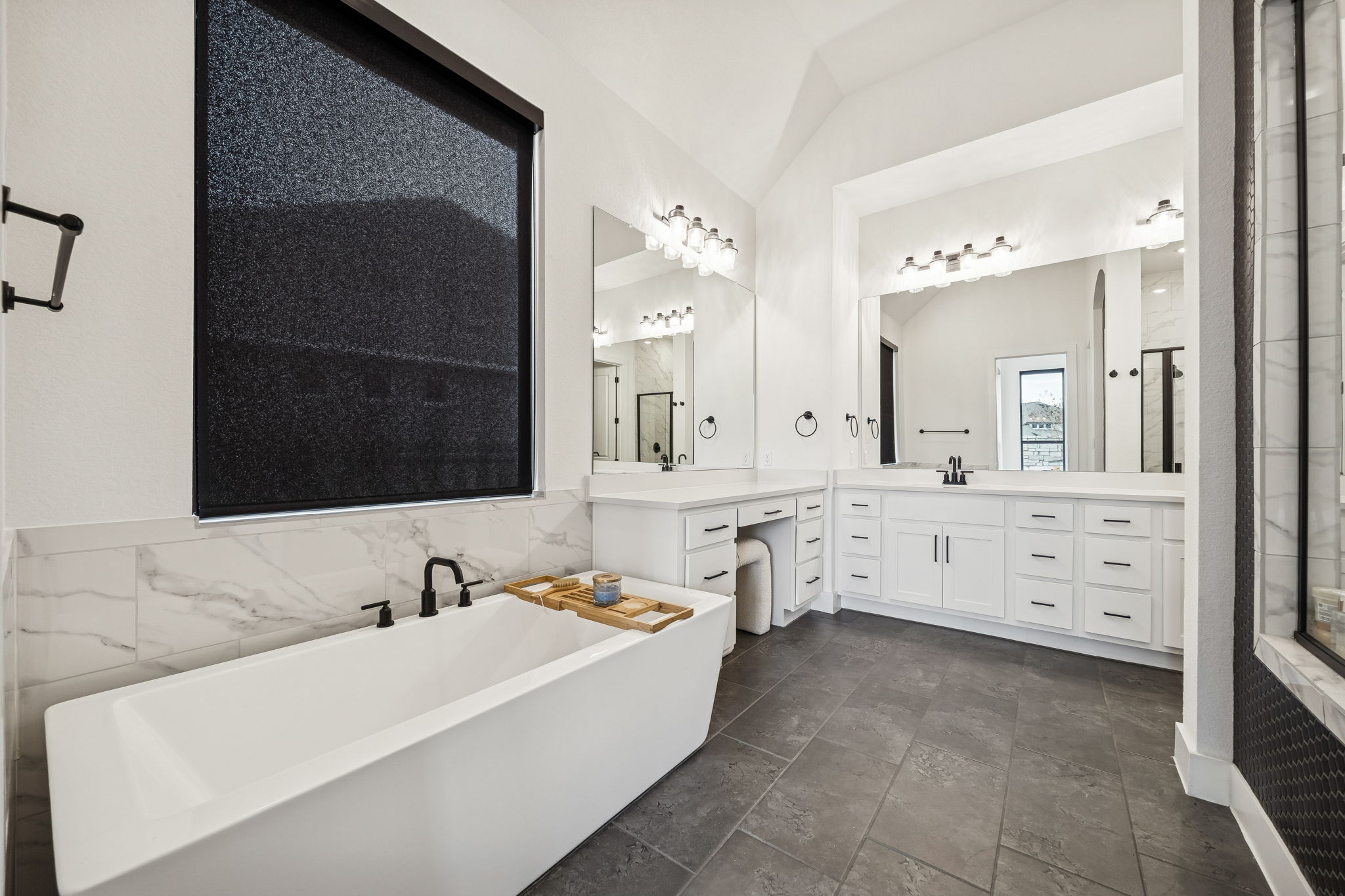 269 Iron Crk Way Kyle, TX 78640 - Photo 7 of 32 a bathroom with a tub sink and mirror
