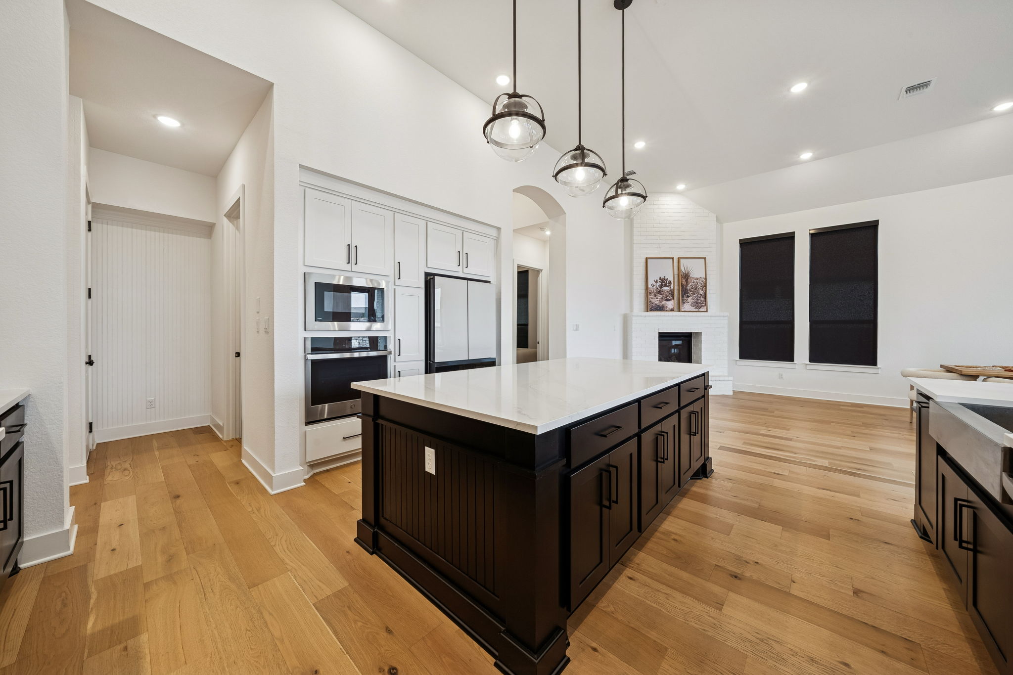 269 Iron Crk Way Kyle, TX 78640 - Photo 8 of 32 a kitchen with stainless steel appliances granite countertop a sink and a wooden floor