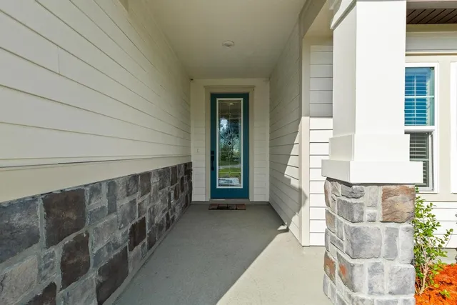 a kitchen with a sink a stove a refrigerator and white cabinets