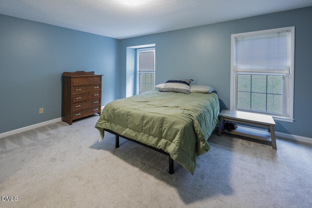 412 Oak Hollow Court Raleigh, NC 27613 - Photo 12 of 24 a bedroom with a bed and a dresser