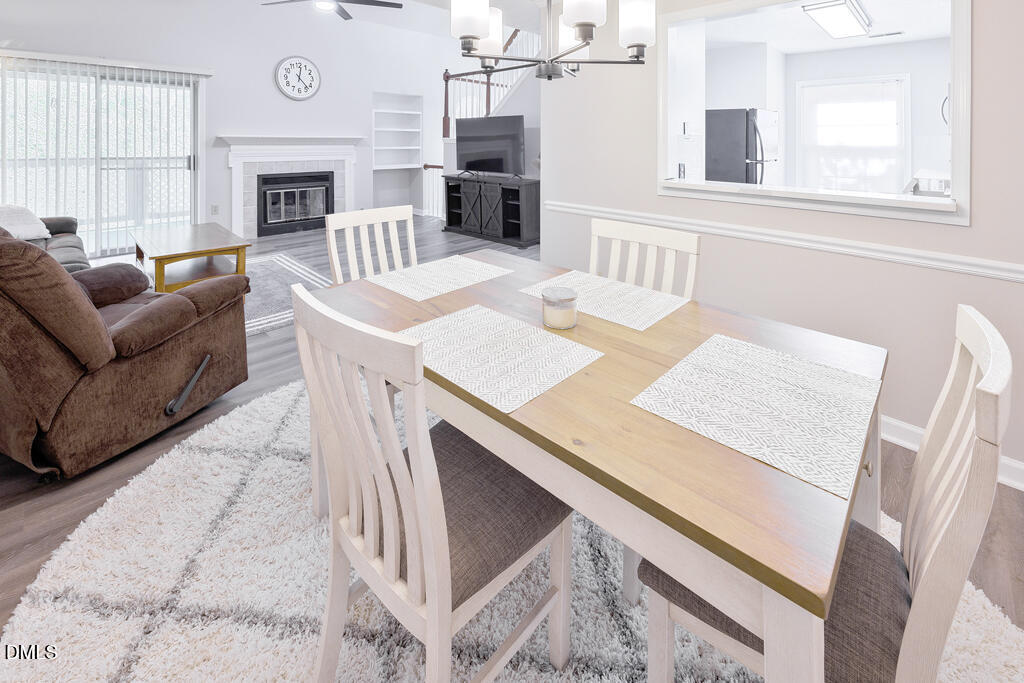 412 Oak Hollow Court Raleigh, NC 27613 - Photo 5 of 24 a living room with furniture a fireplace and a large window