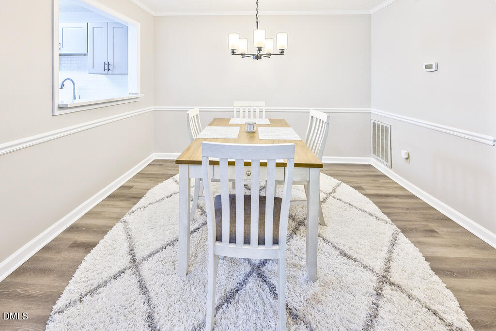 412 Oak Hollow Court Raleigh, NC 27613 - Photo 9 of 24 a view of a dining room with furniture and wooden floor