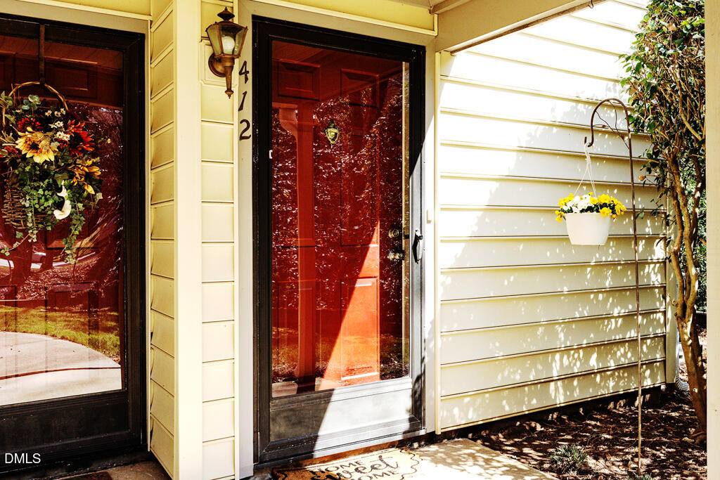 412 Oak Hollow Court Raleigh, NC 27613 - Photo 10 of 24 a view of front door of house with a porch