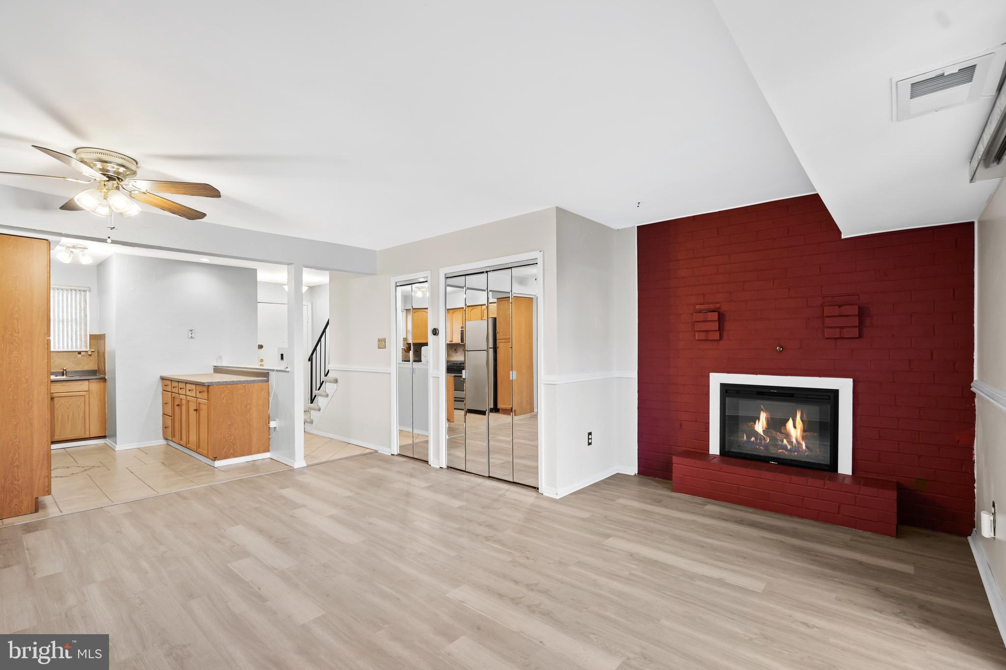 a view of a livingroom with a fireplace and window
