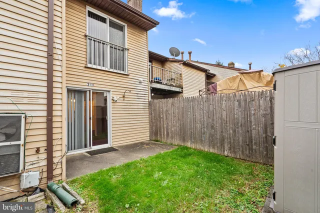 a view of a backyard with wooden fence