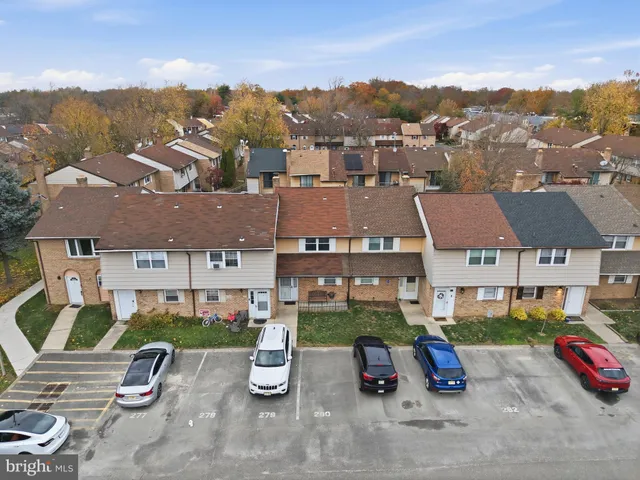 an aerial view of a house with garden space and street view