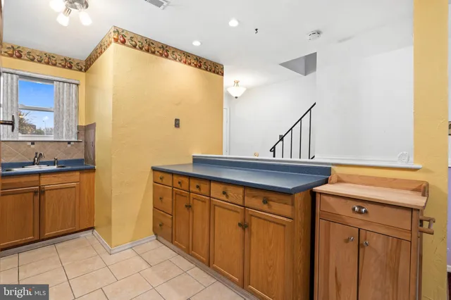 a kitchen with stainless steel appliances granite countertop a sink and cabinets