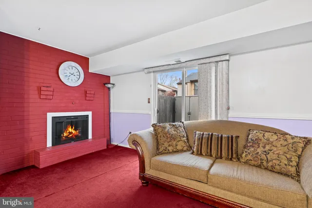 a living room with a couch and a fireplace