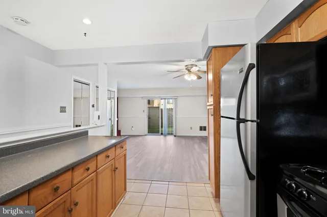 a view of a kitchen with a sink and refrigerator