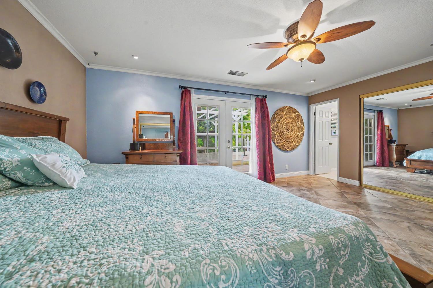 6364 Baldwin Street Valley Springs, CA 95252 - Photo 41 of 72 a bedroom with a large bed and a large window