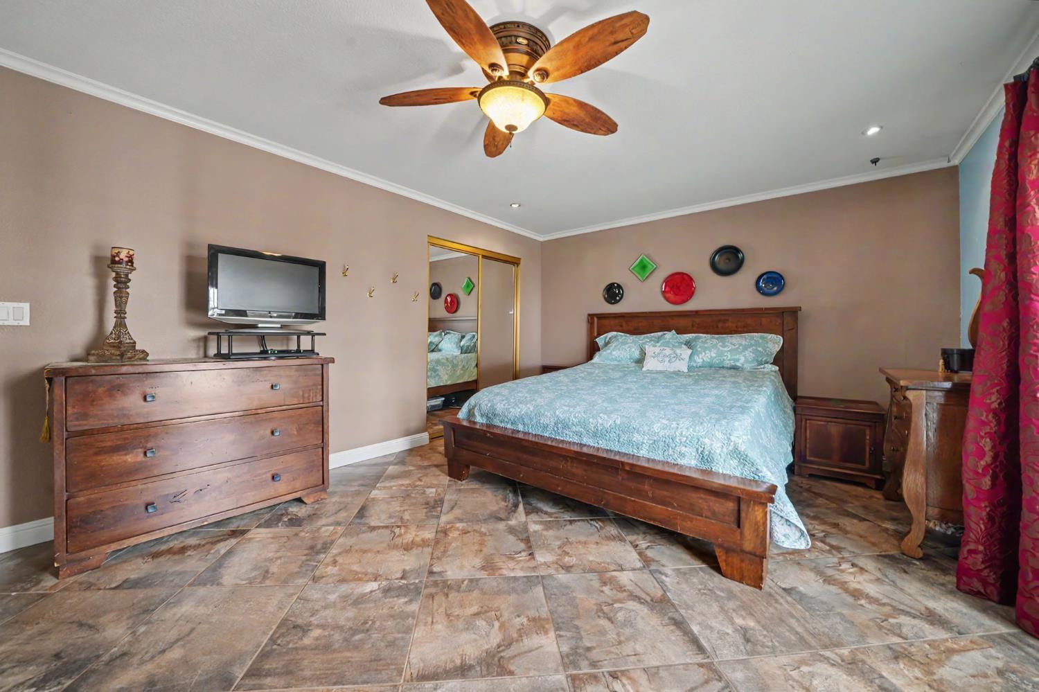 6364 Baldwin Street Valley Springs, CA 95252 - Photo 43 of 72 a bedroom with a bed and a flat tv screen on dresser