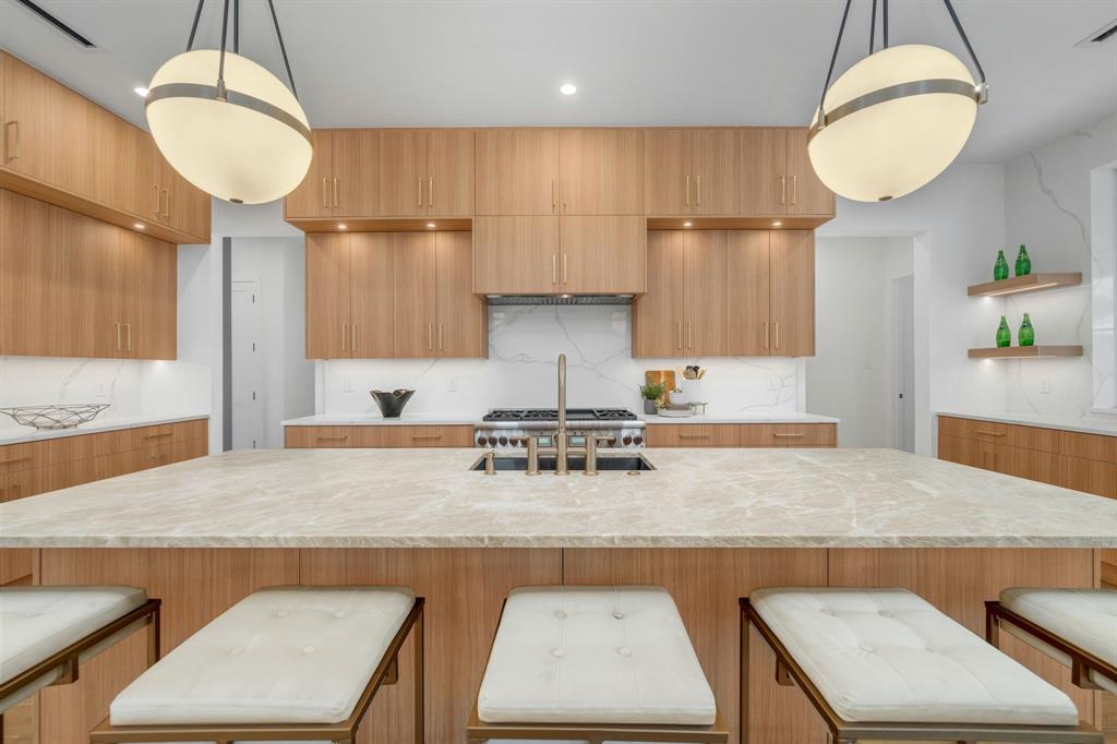 3627 Merrell Road Dallas, TX 75229 - Photo 12 of 39 a kitchen with kitchen island a counter and a sink