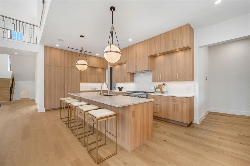 3627 Merrell Road Dallas, TX 75229 - Photo 13 of 39 a kitchen with stainless steel appliances granite countertop a sink a stove and a wooden floors
