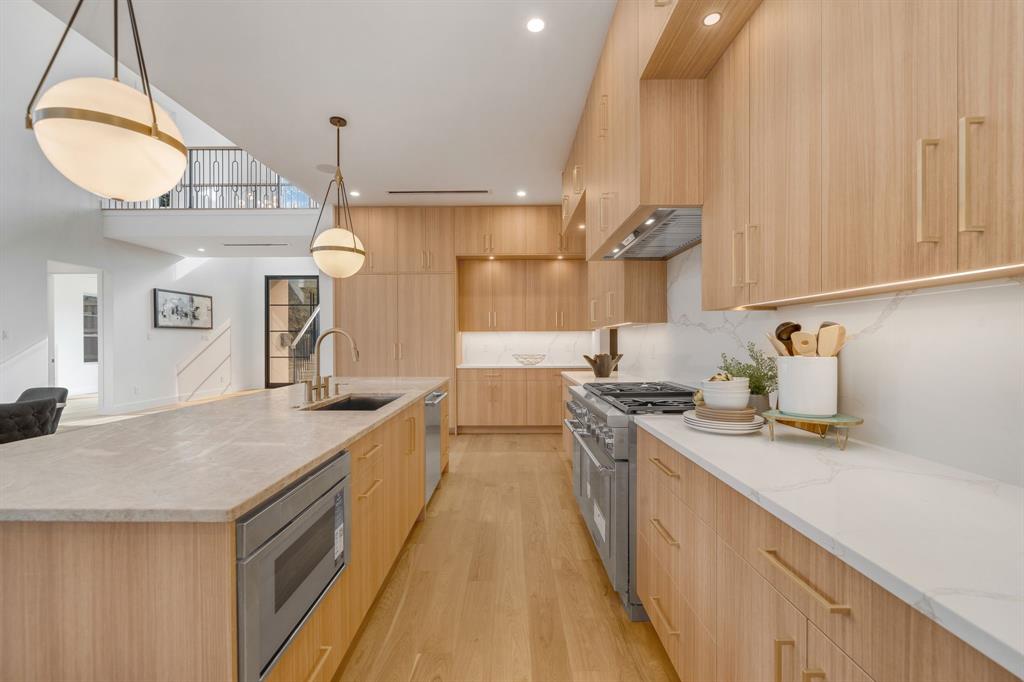 3627 Merrell Road Dallas, TX 75229 - Photo 14 of 39 a kitchen with stainless steel appliances granite countertop a sink a stove and a wooden floors