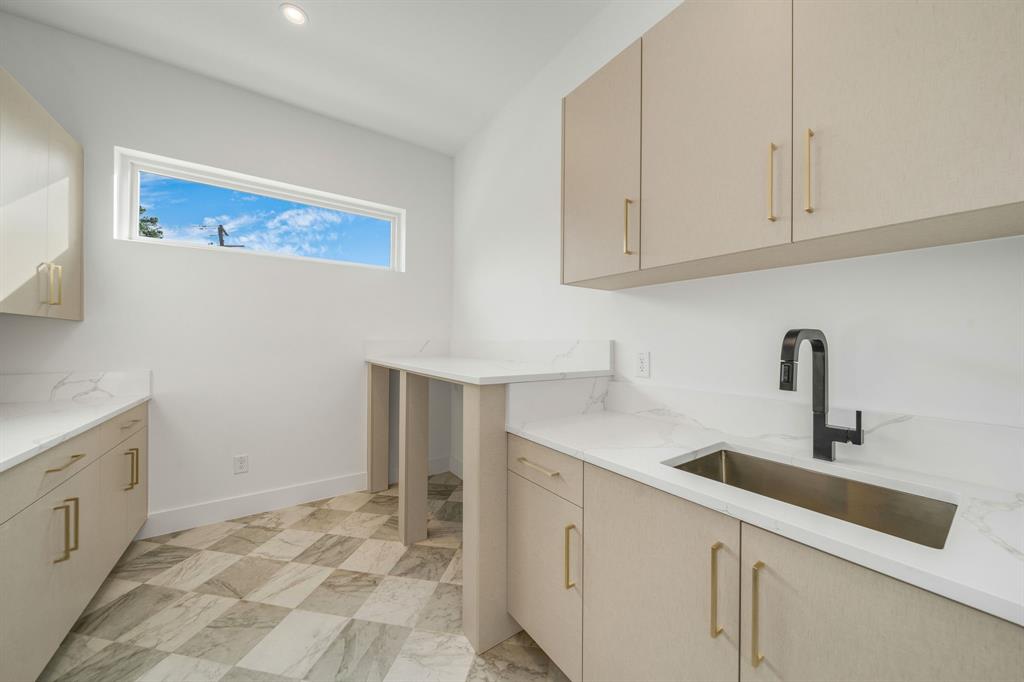 3627 Merrell Road Dallas, TX 75229 - Photo 21 of 39 a kitchen with white cabinets a sink and dishwasher