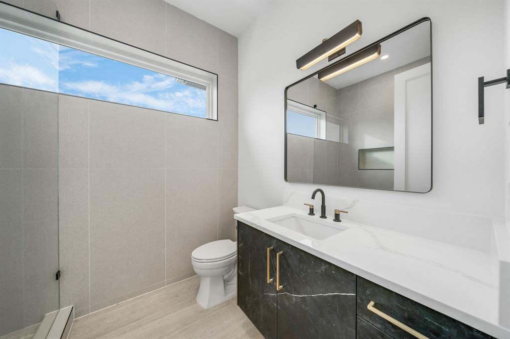 3627 Merrell Road Dallas, TX 75229 - Photo 29 of 39 a bathroom with a sink and a mirror
