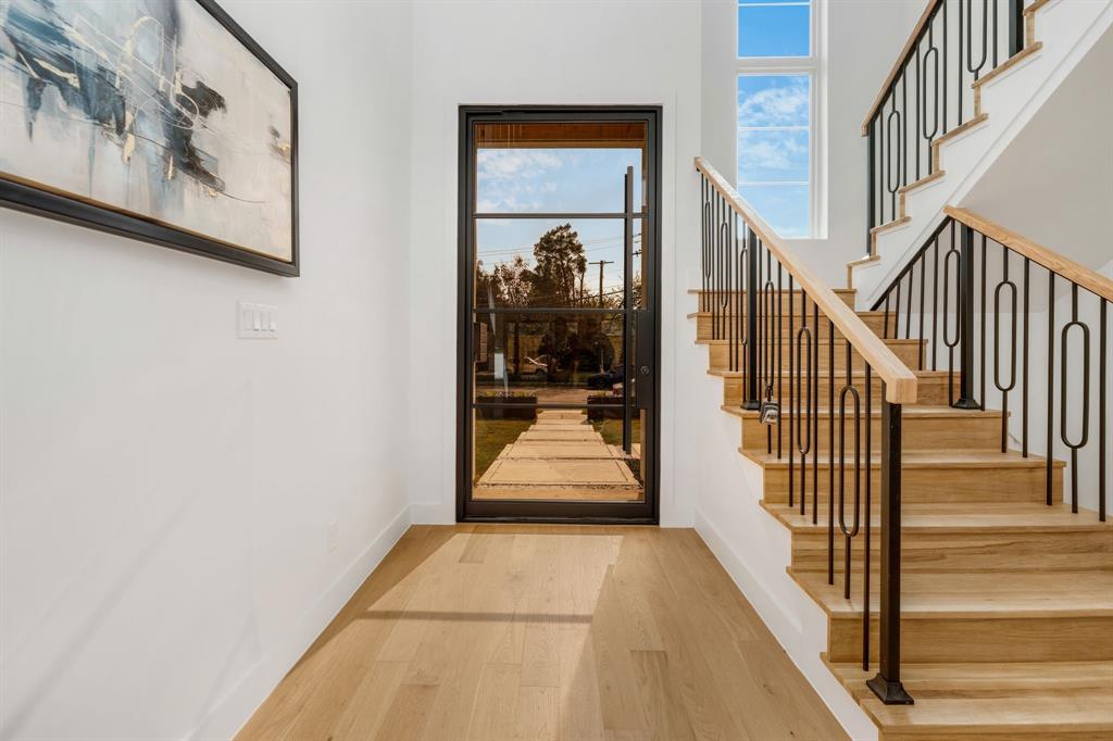 3627 Merrell Road Dallas, TX 75229 - Photo 5 of 39 a view of a hallway with wooden floor and windows