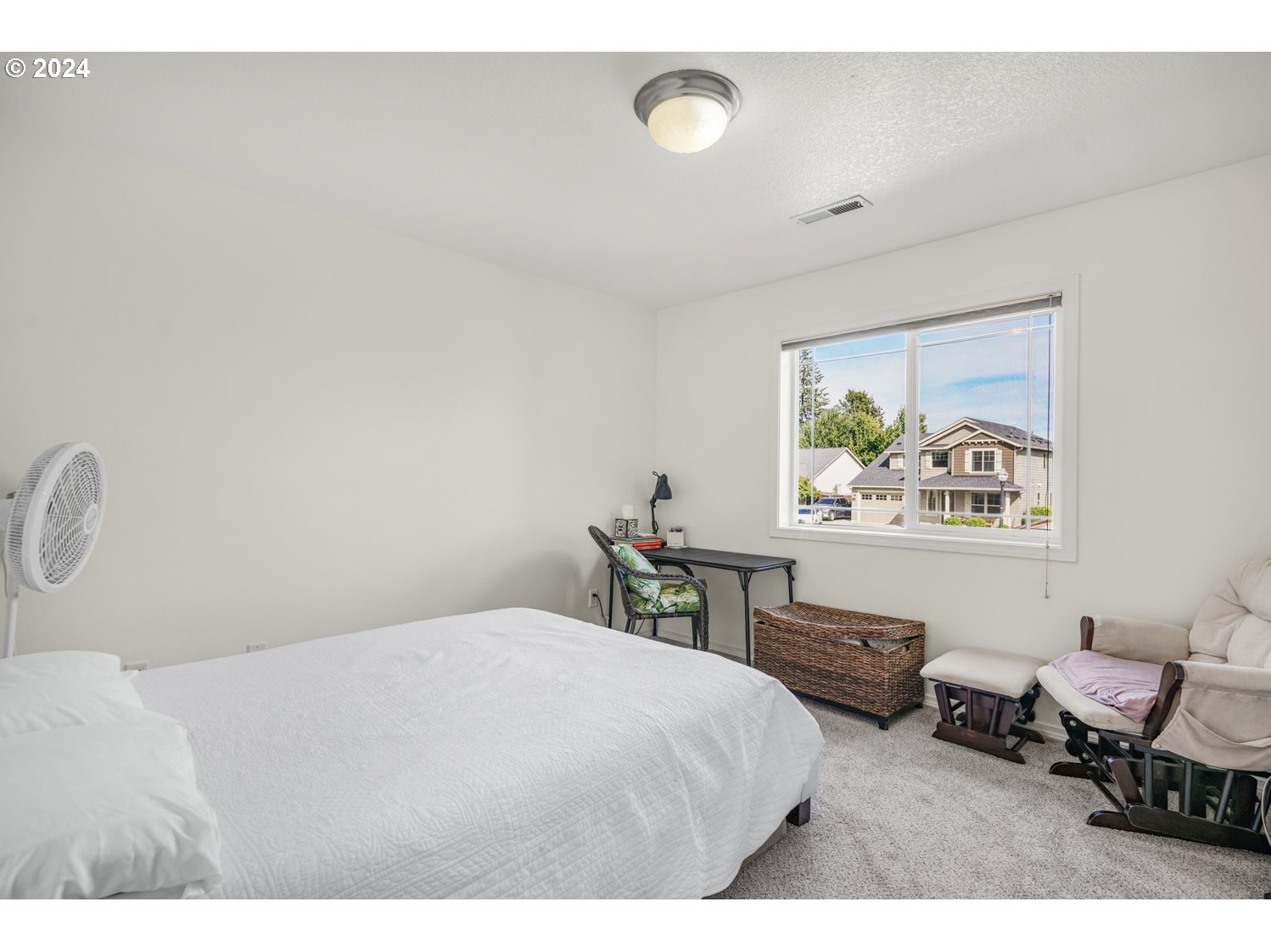 1514 West E Place La Center, WA 98629 - Photo 12 of 26 a bedroom with a bed a table and chair