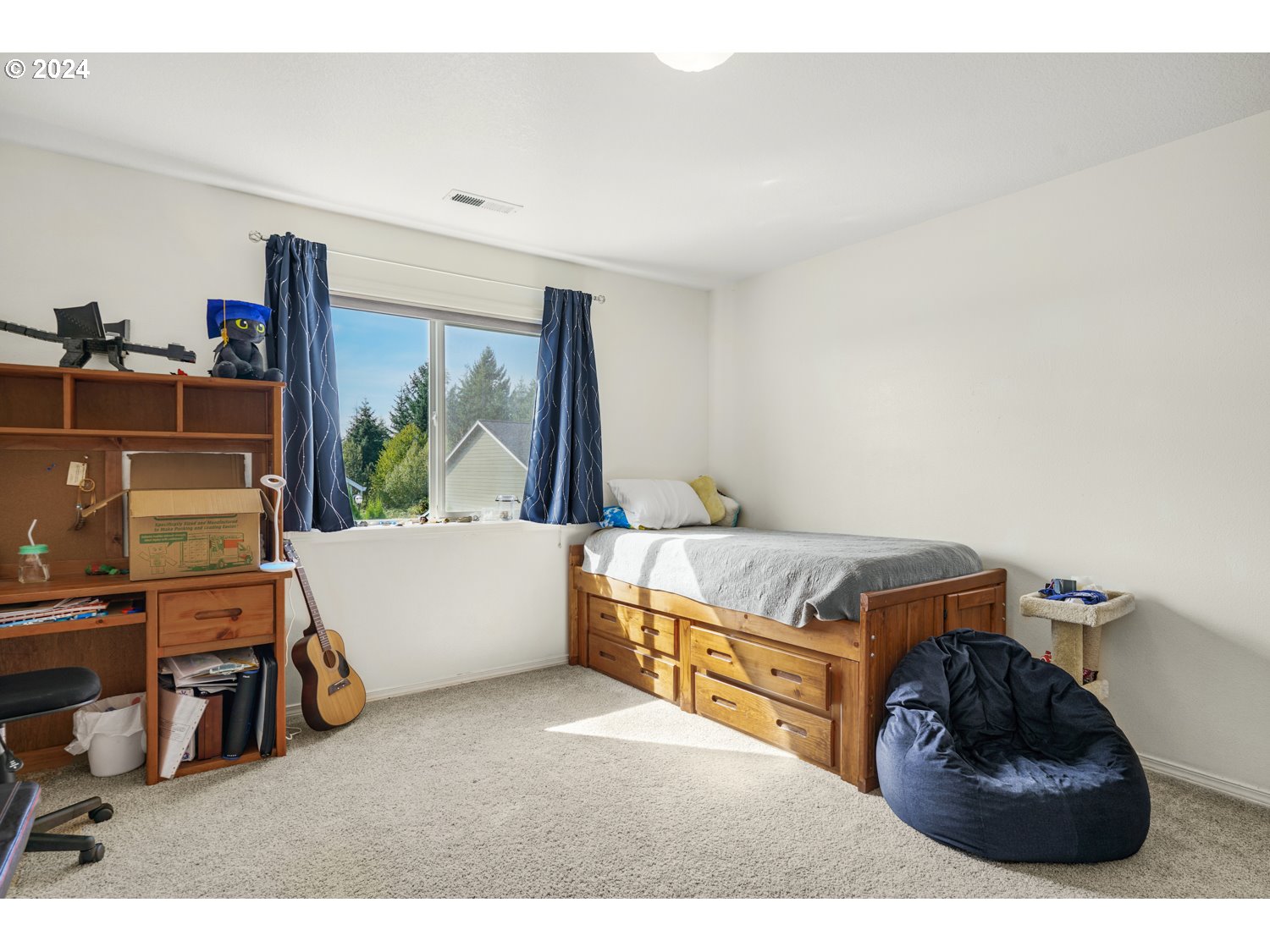 1514 West E Place La Center, WA 98629 - Photo 14 of 26 a living room with a couch and a dresser next to a window