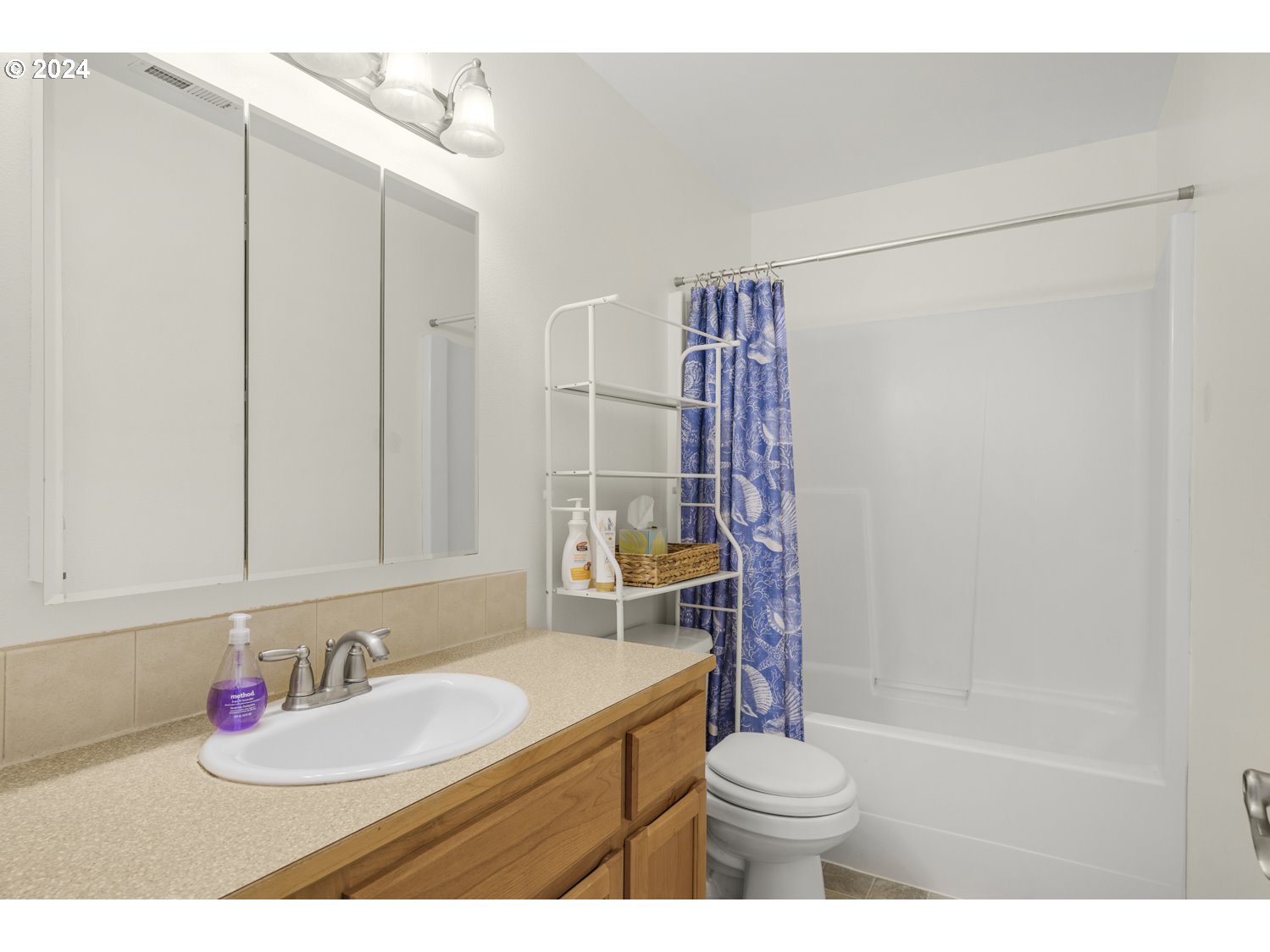 1514 West E Place La Center, WA 98629 - Photo 17 of 26 a bathroom with a sink a toilet and a shower