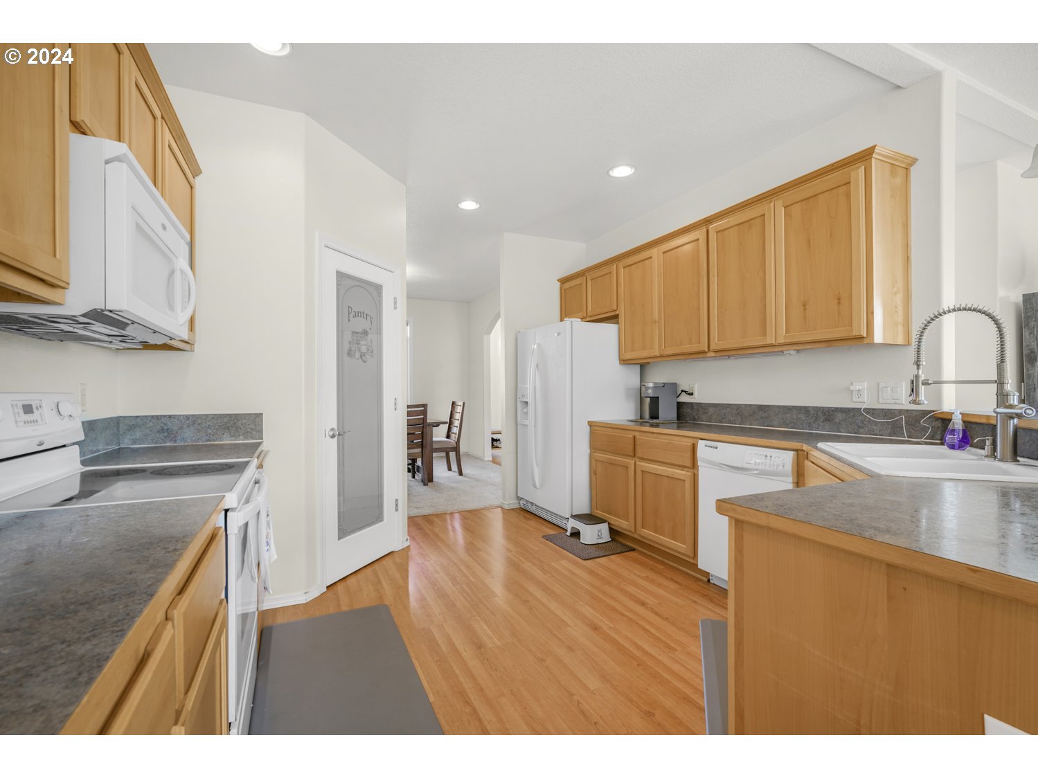 1514 West E Place La Center, WA 98629 - Photo 5 of 26 a kitchen with stainless steel appliances granite countertop a sink stove and refrigerator