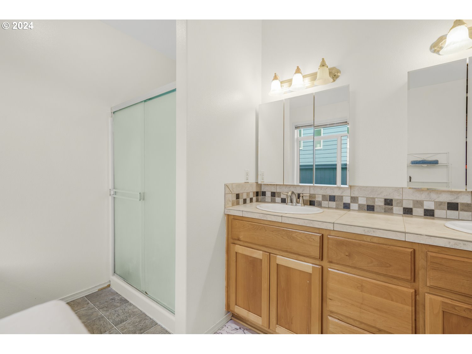 1514 West E Place La Center, WA 98629 - Photo 10 of 26 a bathroom with a sink vanity and mirror