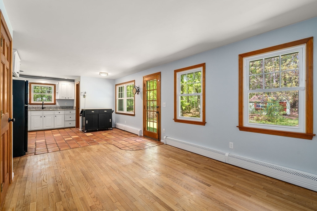 405 Harvard Road Bolton, MA 01740 - Photo 12 of 38 a view of an empty room with kitchen and windows
