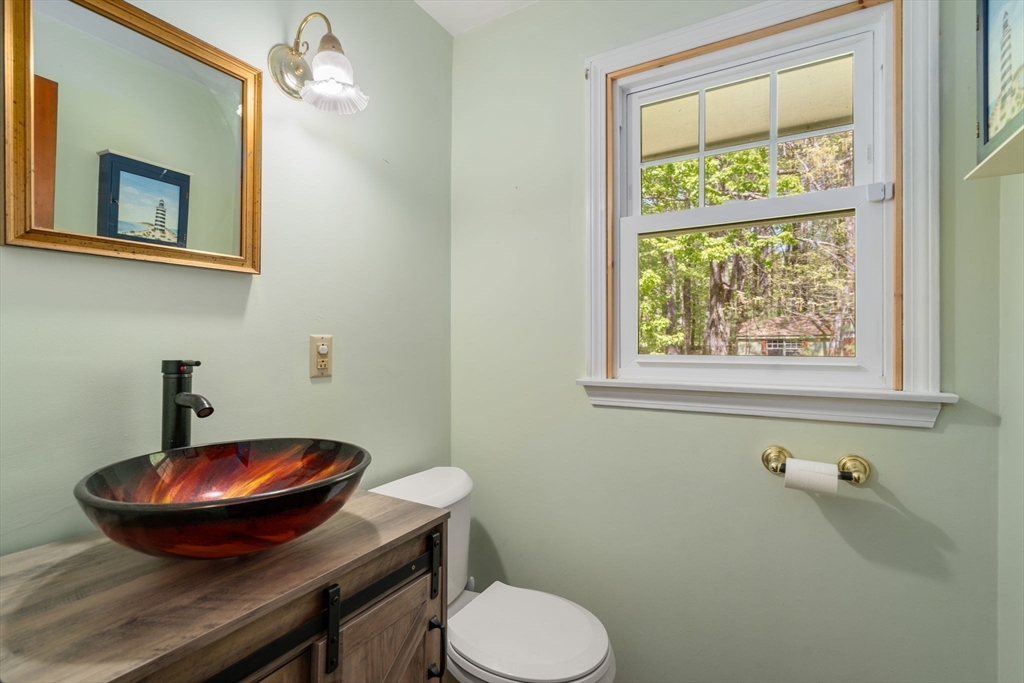 405 Harvard Road Bolton, MA 01740 - Photo 13 of 38 a bathroom with a toilet sink and mirror