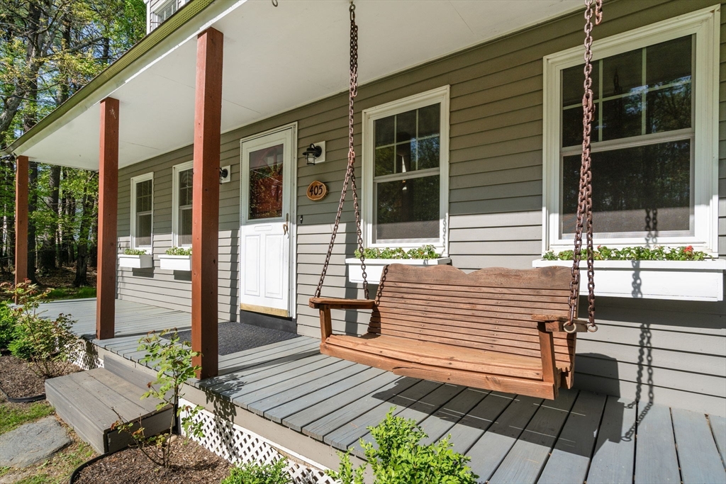 405 Harvard Road Bolton, MA 01740 - Photo 3 of 38 a view of a chairs on the deck