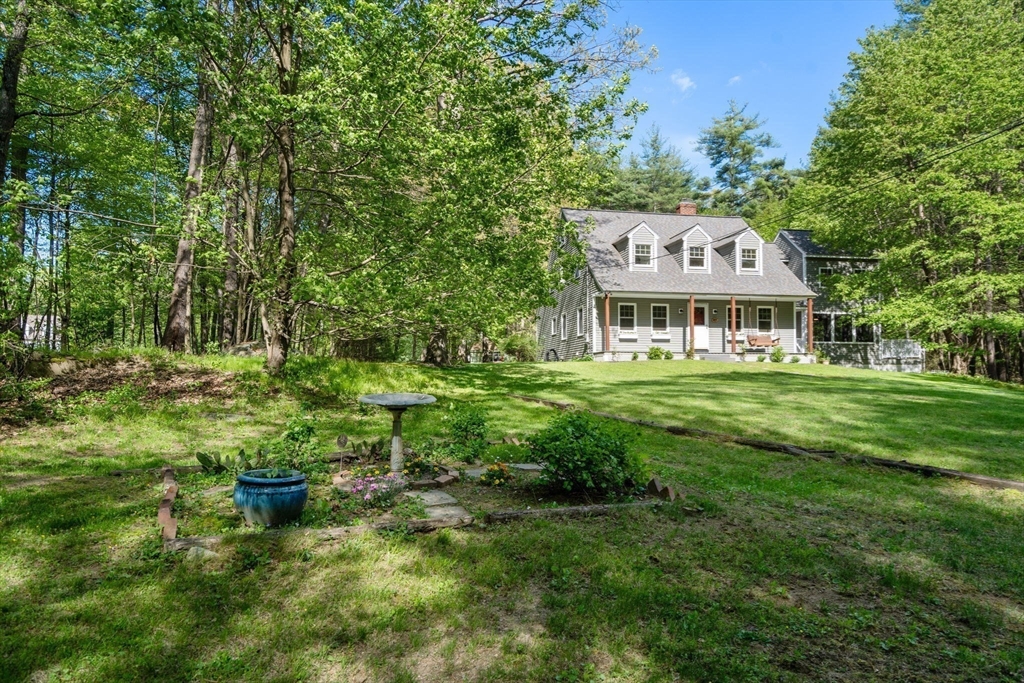 405 Harvard Road Bolton, MA 01740 - Photo 34 of 38 a front view of a house with a yard