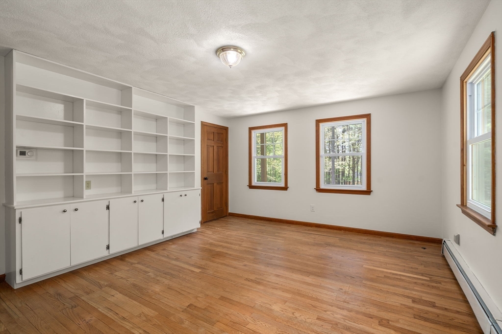 405 Harvard Road Bolton, MA 01740 - Photo 6 of 38 wooden floor in an empty room with a window