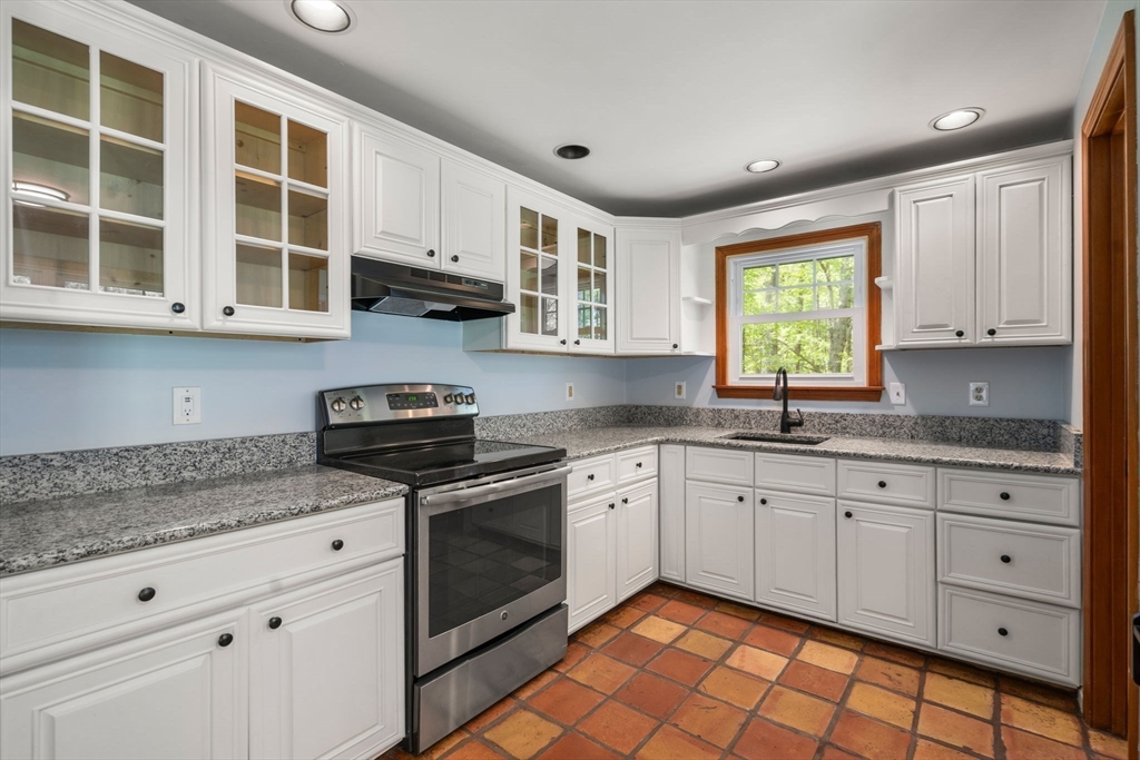 405 Harvard Road Bolton, MA 01740 - Photo 9 of 38 a kitchen with stainless steel appliances granite countertop a stove a sink and a granite counter tops