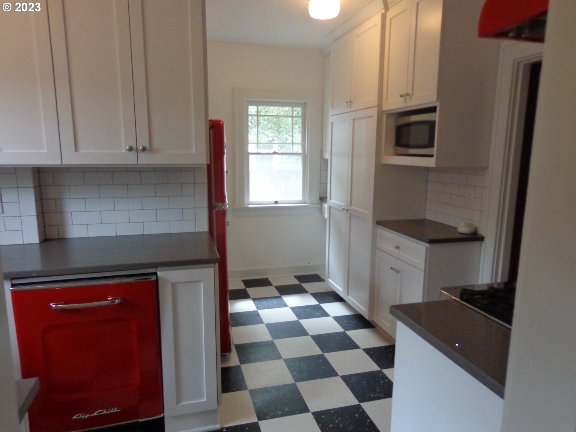 704 Southeast Umatilla Street Portland, OR 97202 - Photo 5 of 17 a kitchen with granite countertop stainless steel appliances a sink and cabinets